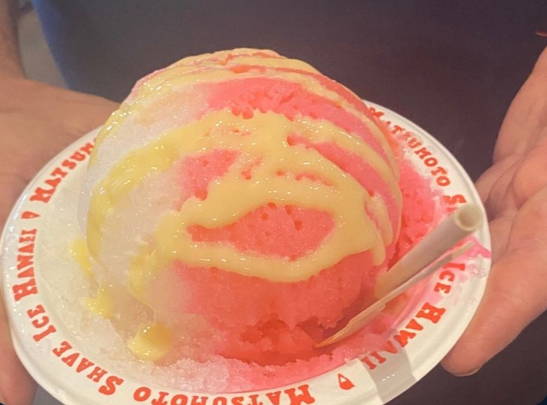 Rainbow shave ice in a paper cup