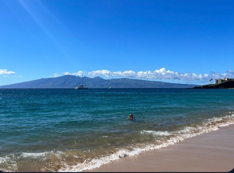 Calm bay with an island on the horizon