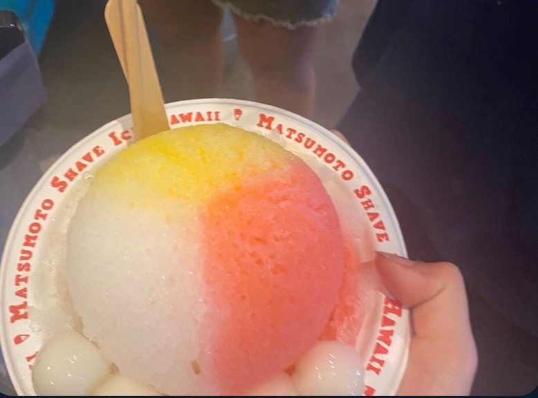 Shave ice held up in a branded cup